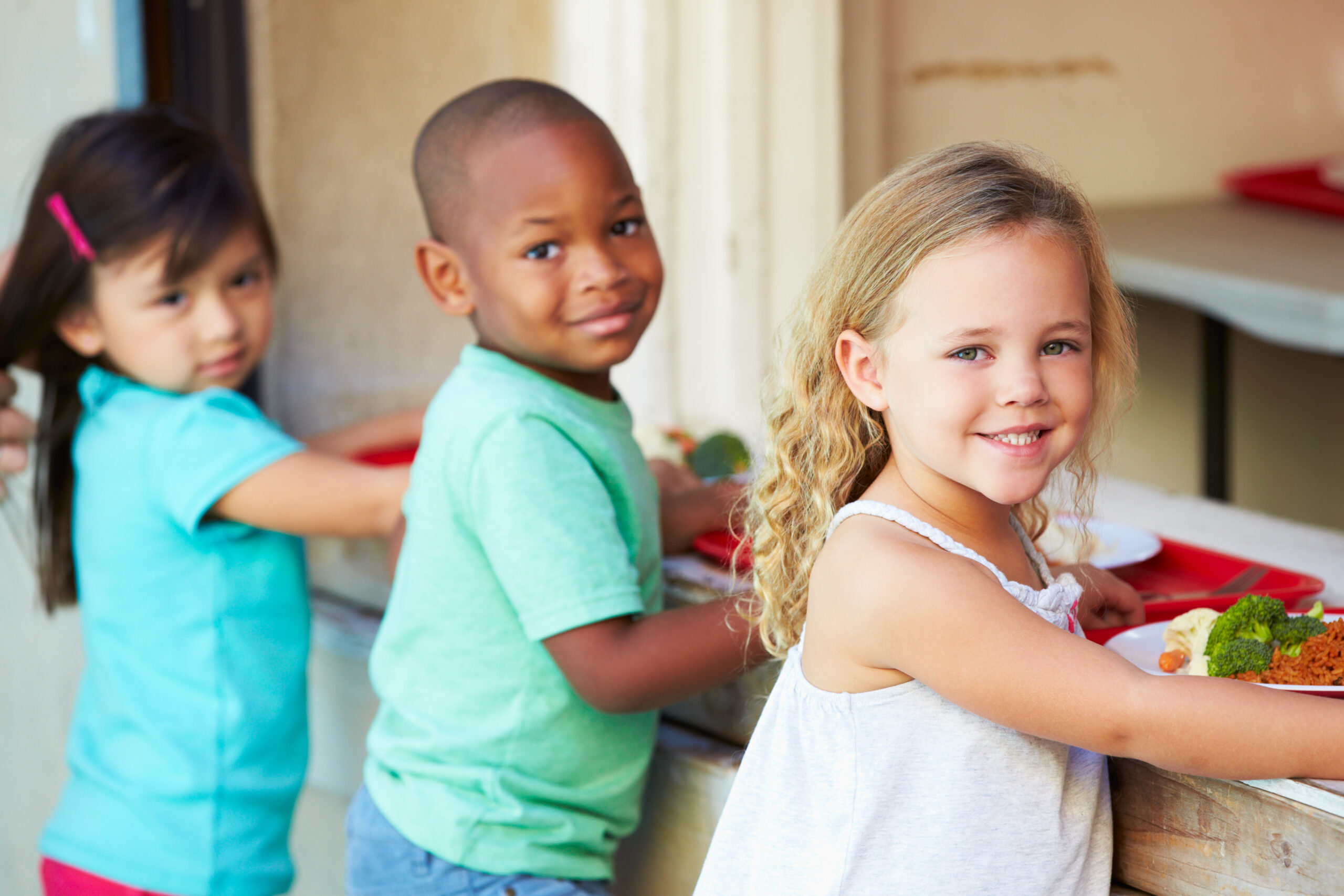 Children going through the lunch line with trays